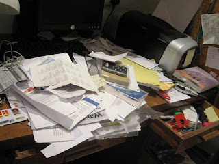 A desk covered in papers