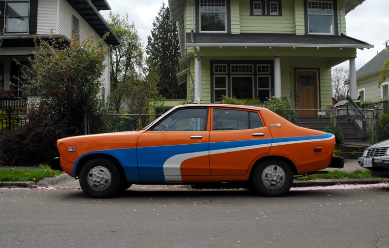 OLD PARKED CARS.: 1977 Datsun B210 Sedan.