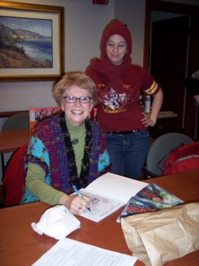 Phyllis Sanford autographing a book for Hava at the HHCC monthly meeting.