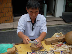 Man making wooden spinning tops