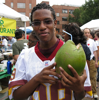 festivalgoer holding green coconut