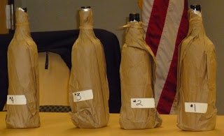 wines wearing brown paper bags