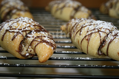 Crescent rolls, spread with Nutella, a little cinnamon sugar and finely minced walnuts. Quick. Easy. Heavenly.