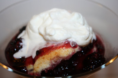 A tender, fluffy sweet buttermilk cobbler dough, dropped like dumplings into freshly stewed blackberries and topped with homemade whipped cream.