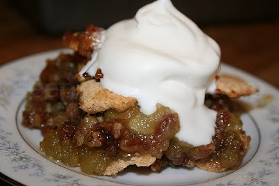 Ozark Pudding, in this baked version, creates a sugar cookie type of topping as the flour rises to the top. Underneath is a gooey, super sweet filling, very reminiscent of pecan pie, so that the dessert becomes somewhat of a cross between that and apple pie.