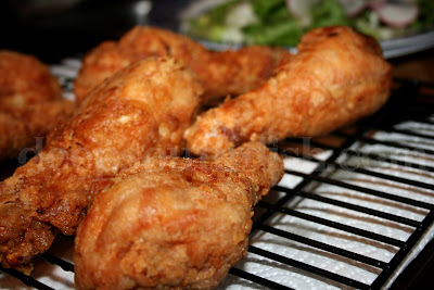 Fried chicken legs marinated in a soy and hot sauce blend, dusted with flour and fried.