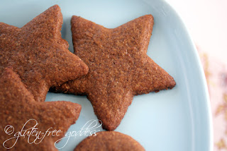 Gluten free vegan gingersnap cookies in star cut out shapes on a plate