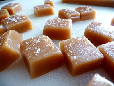 Homemade salted caramel candies on a cutting board. 