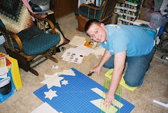 Kyle is cutting triangles for a fractal geometry quilt he made