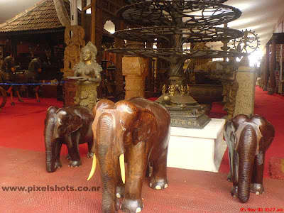 elephants statues made of timber for sale in an antiques and sculpture shop in jew street of kerala cochin india,timber sculptures,ganesha made of timber,polished timber sculptures,big ganapathy timber carving