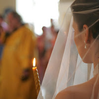 Bride walking with lit memorial candle
