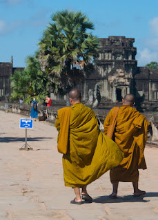 monks at angor wat in orange robes