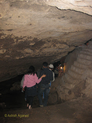Couple entering the dark cave to reach the Jata Shankar shrine in Pachmarhi