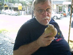 SIPPING THE JUICE OF A YOUNG COCONUT AT KARON BEACH PHUKET FEB. 2008