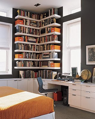 bedroom with brown walls, white shelves, orange boxes, orange bedding