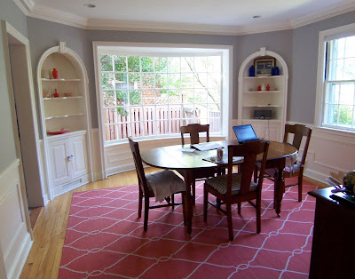 large curved window in gray dining room