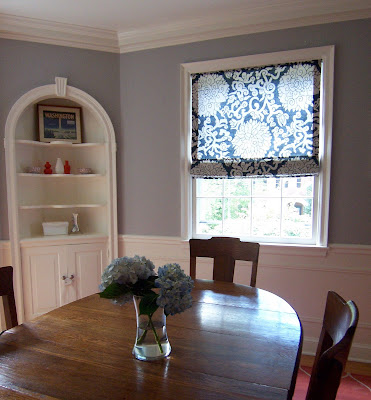 gray dining room with blue floral Roman shade
