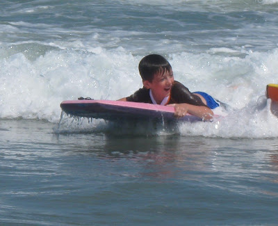 Boy playing in waves