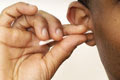 man using ear swabs