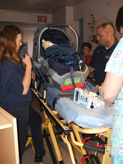 Getting the car seat strapped to the stretcher