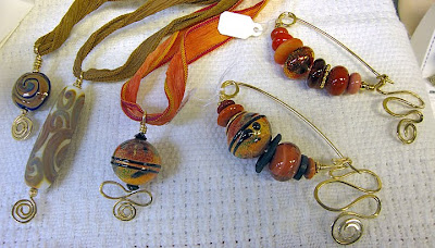bead jewelry by Robin Atkins, fibula pins and pendants
