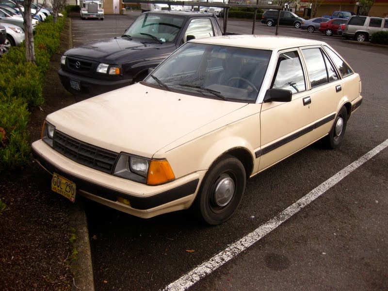 OLD PARKED CARS.: 1983 Datsun/Nissan Stanza 4-Door Hatchback. OLD PARKED CARS.: 1983 Datsun/Nissan Stanza 4-Door Hatchback.