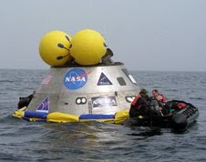 Members of the 920th Rescue Wing work on a mockup Orion crew exploration vehicle off the coast of Port Canaveral, Fla.