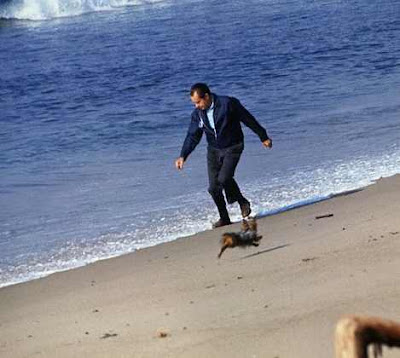 Nixon on the beach in wingtips and suit