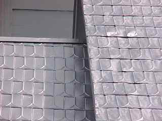 Old and new shingles are coated with same silvery formula