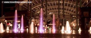 PHOTO JOURNEY of Unimaginable Luxury of UB City in Banglore, INDIA : Posted by VJ SHARMA on www.travellingcamera.com : During my recent visit to Banglore, I visited UB city which known as biggest mall in Banglore City. Here are few photographs of UB City with few details a bout it... Check out !!!Here is entry to the parking of UB city in Banglore ... On entering into the parking, we parked our Maruti Also in the middle of BMW and Bentley !!! I wanted to click a photograph but it was not allowed inside the parking... 1100 cars can be parked at a time...UB City is considered as  biggest commercial property project in Bangalore, in Karnataka state of India. It is pioneered by the chairman of UB Group, Mr.Vijay Mallya. This whole complex is built on 13 acres of land On entering inside UB City, it looked like a 5 star hotel with Foreigners all around....UB City is located in the heart of Bangalore City. UB City is at corner of Vittal Mallya Road and Kasturba Road.... It's just 800 m. away from the famous M. G. Road in Baglore City...Children having fun near water fountains in the middle of UB City in Banglore..In UB city there are four towers named as - UB Tower, Comet, Canberra and Concorde... UB Tower has 19 Floors, Comet has 11 Floors and the name Comet is derived from an aircraft.. Same for the other two towers Canberra and Concorde, both of them are derived from an aircraft name. Canberra has 17 floors and Concorde has 19 floors...There are lot of resturants around an open area in the middle of this campus... Here is a photograph of The Tasty Tangles inside UB City... Its near to the open Amphitheater...I was told by someone that UB City has Group offices under one roof  of UB Towers. Concorde and Canberra have retail space on the lower floors and office space in the higher levels...But Comet has luxury serviced apartments...A photograph of a showroom of interiors ... Most of the brands there were very expensive and I heard of those first time. We came across a showroom of watches and mobiles.. though of looking at their products... First two mobiles we saw their were having price tag of 5.66 Lacs and 3.45 Lacs... I forgot the name of that brand.Comet tower has some commercial offices, banks, high-end retail stores, a five star hotel, luxury service apartments, restaurants, food courts, pubs, health clubs and cafes....I have also heard of a helipad on the roof top of UB City !!There are some water fountains in the middle of UB City surrounded by colorful lights... Children love these fountains and parents have to set a time limit on them to go & have some food...Rohin also wanted to have a photograph inside the water area in UB City, Banglore..Here is another photograph of colorful fountains inside UB City...Lot of people around these colorful water fountains in UB City @ Banglore, Karnataka, INDIAHere is the entrance for various showrooms... We spent some time there, but didn't buy anything there...Another photograph of same place @ UB City in Banglore...Check out more details about the place @ http://www.thecollection-ubcity.com/A Lamp shade hanging on walls of a Restaurant inside UB city....There were lot of cute babies around these water fountains and they were really enjoying the play with these water sprinklers .... Everyone had different style of teasing these fountains... I clicked lot of babies and would love to share other photographs soon... Some of the parents asked me to send their photographs by Email and I am already done with that :)Lavishly decorated Lift area of UB City at Banglore... Its a beautifully constructed building which is a great example of a great lifestyle in side the city...Stairs for the ground floor of the complex where all the showrooms we have.. There are some nice bars and restaurants on first floor of this complex....Here is a photograph of Parking slip @ UB City Banglore. If I remember correctly, they take it back and doesn't allow visitors to take them back.. We requested him but he denied politely..There are some fully serviced Residences inside UB City by the name of Oakwood...