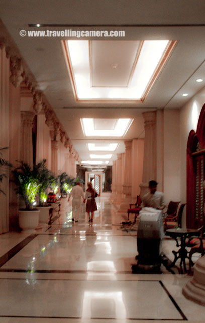 A Quick Photo Journey to Leela Regency Hotel in Banglore : Posted by VJ SHARMA on www.travellingcamera.com : During the recent visit to IT City of India, Banglore, I spent some time in Leela Regency with few of my friends... Here are few photographs I was able to click at this place.. Check Out...Architecture of this hotel is really very different... I think its a 5 Star Hotel and had some very nice restaurants...A Photograph of front entry to the Hotel ...I don't know what exactly we call to these kind of parkings, where sturdy iron poles can handle three cars one above the other with appropriate separators, which can be lifted up and down without disturbing other two cars...Sitting area around Barista inside Leela Regency...Another Photograph of Artistic Pillars inside Leela Regency in Banglore....Passage from main Lobby of the Hotel towards Barista...I was not very comfortable with idea of clicking photographs there, because all the people around me were noticing the sound of my shutter.... Thanks to Rohin for encouraging me and making me click these very quickly :) Hotel has nice garden on the boundaries and here is a photograph of an artificial waterfall in one of the gardens... Lovely place to roam and sit around...Photograph of one side of the Hotel clicked from the garden... Very low light and no tripod :(Mid Night Coffee Sessions in Barista which is inside Leela Regency...So I had few visits to the Hotel during 5 days of my stay and it was limited to Coffee Sessions at Barista and nothing else... Other good part was Fried Rice @ a roadside kiosk behind the hotel... Thanks to Rohin and his friends for wonderful stay in Banglore !!!