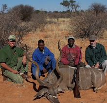 PH Harry Claassens on left, two of his trackers, and Mike Roden with kudu he took at 250 yards.