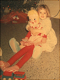 Daughter holding one of her first dolls