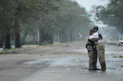 U.S. Air Force Pararescueman Staff Sgt. Lopaka Mounts receives a hug from a resident during search and rescue operations after Hurricane Ike in Galveston, Texas September 13, 2008