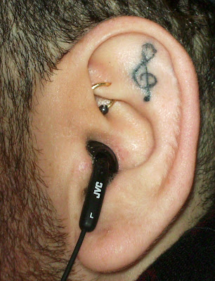 He had this musical symbol (the treble, or G Clef) tattooed in his left ear,