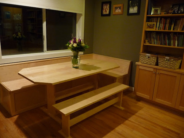 Custom built table and L shaped bench with storage below.