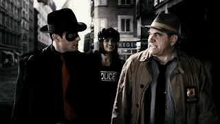 The Spirit (Gabriel Macht, left), Officer Morgenstern (Stana Katic) and Commisioner Dolan (Dan Lauria)keep the streets of Central City safe for honest citizens. It's too bad they couldn't stop Frank Miller.