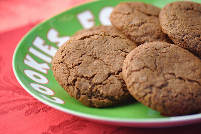 Photo shows large molasses cookies on a green plate