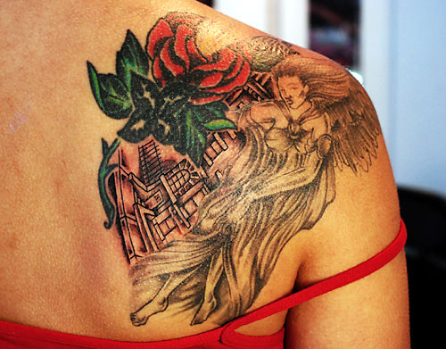 Girl with rose shoulder tattoo.
