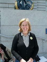 Cindy Sheehan sitting in front of museum
