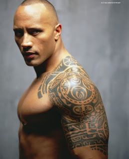 Dwayne "The Rock" Johnson poses with shoulder tattoo.