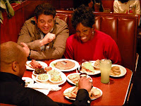 Man v. Food - Adam Richman sitting at a booth with Gladys Knight at Gladys Knight and Ron Winans Chicken & Waffles in Atlanta, GA