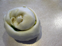 Morsels of Life - Cong You Bing (Chinese Scallion Pancakes) Step 8 - Roll up the dough into a cylinder, and then roll the cylinder so that none of the filling is exposed, forming a circle.