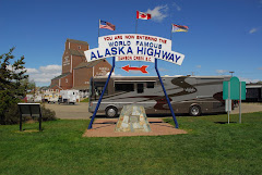 View of the Start of the Alaska Highway Sign Near the Visitor's Center in the Background