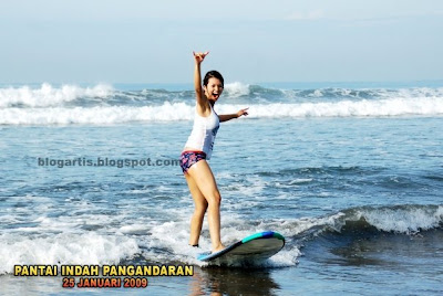 Farah Quinn surfing on the beach Photos
