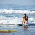 Farah Quinn surfing on the beach