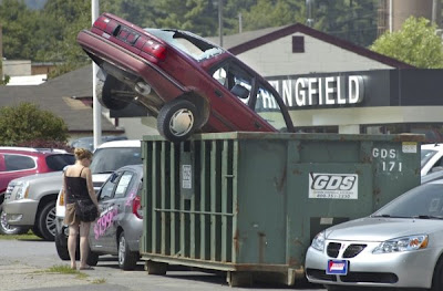 Image of car in dumpster