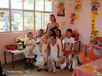 kindergarten schoolchildren with donated school supplies in class