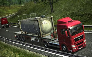truck on road hauling large tank
