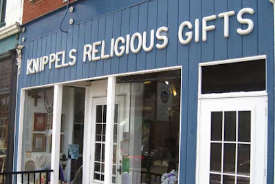 Storefront with sign over window - Knippels Religious Gifts